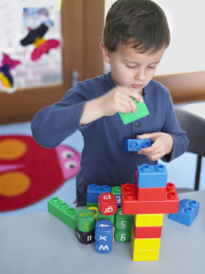 boy putting together blocks